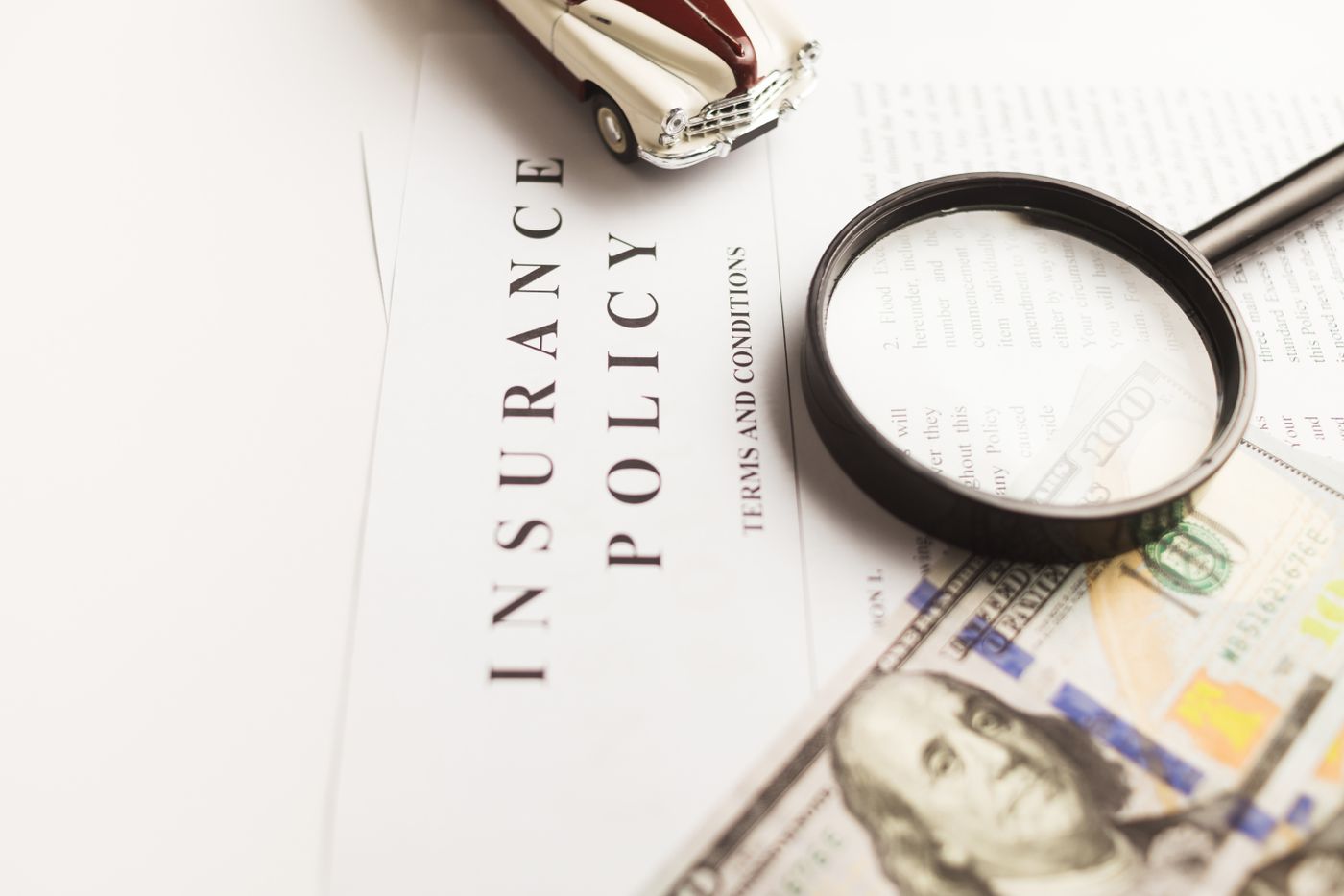 Car insurance documents and keys used for claim and renewal assistance